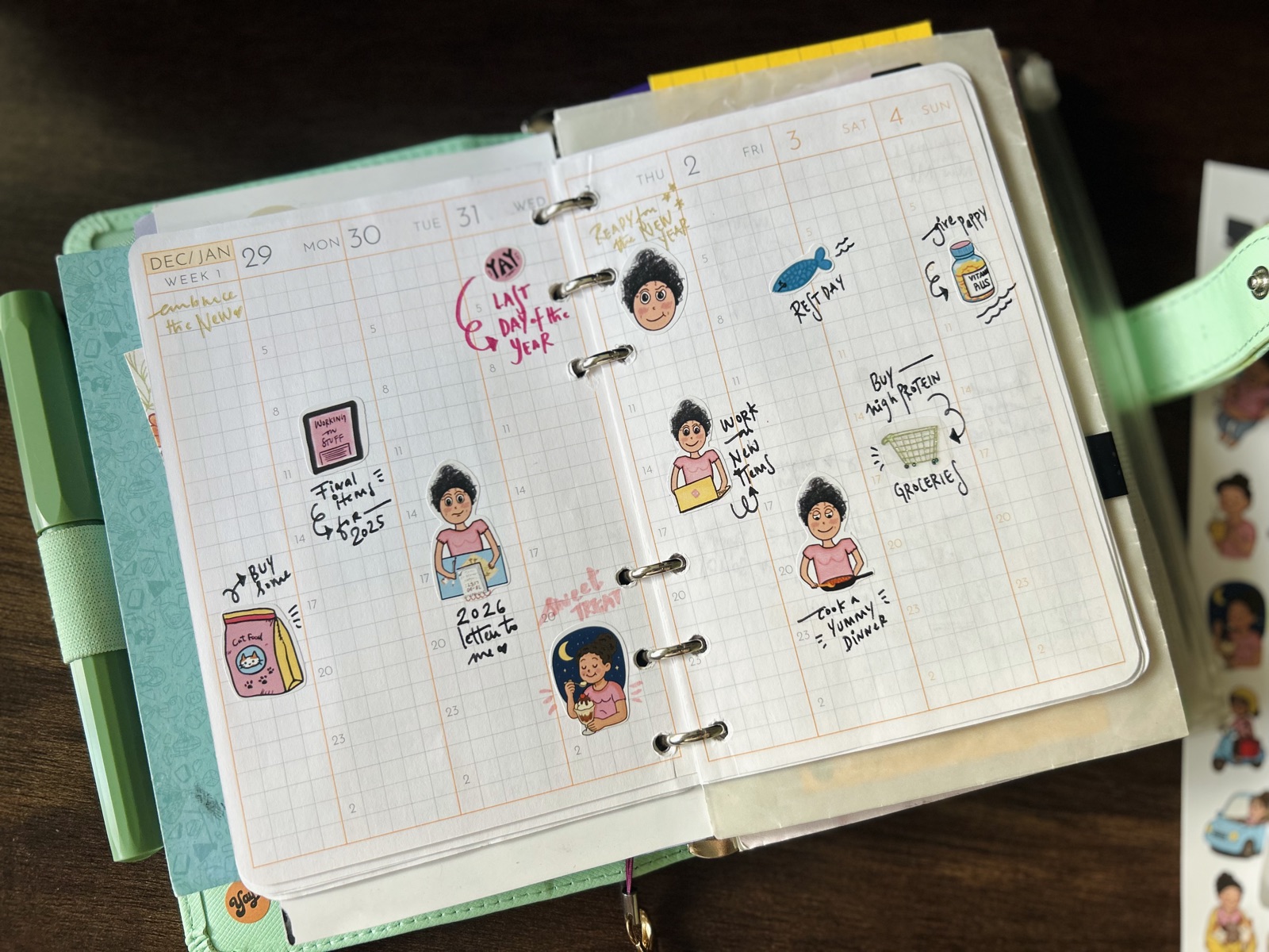 A weekly planner spread decorated with Curvy Noodle stickers featuring various emotions and activities, with a sticker sheet resting alongside the planner.